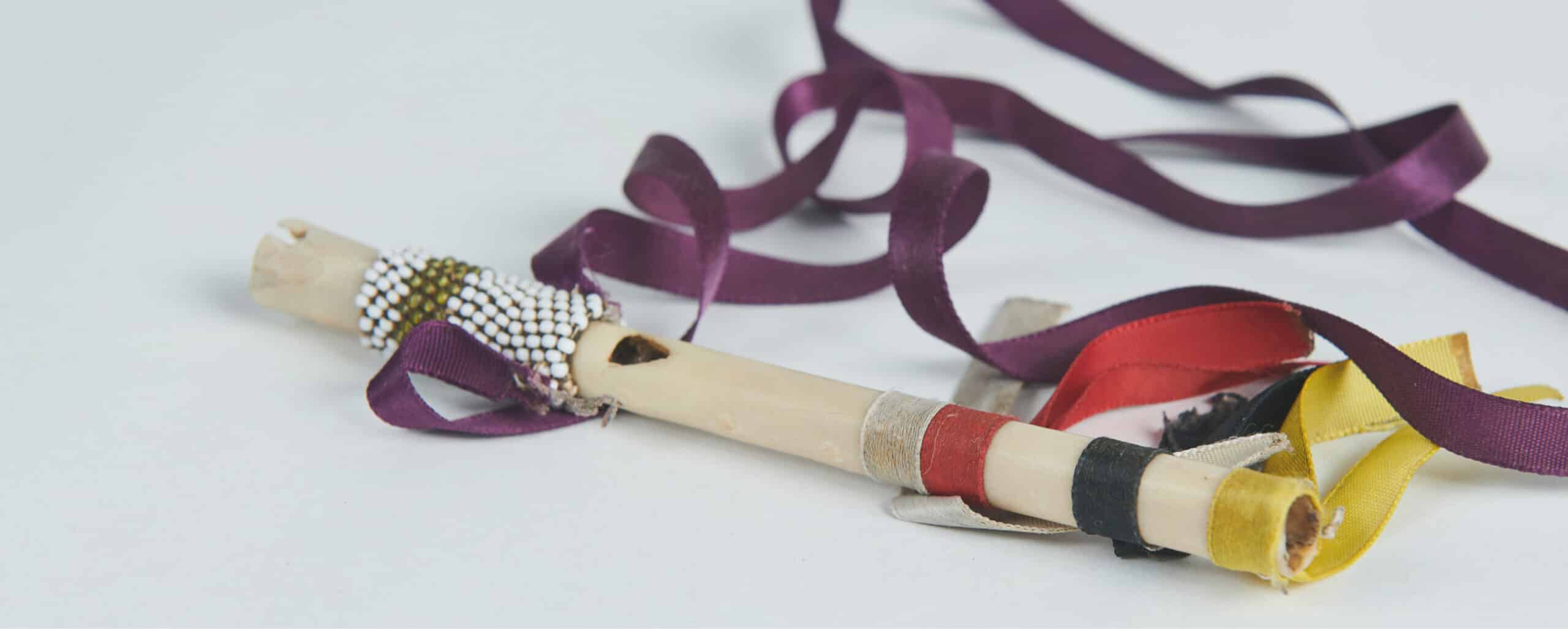 Indigenous talking stick on a white table.
