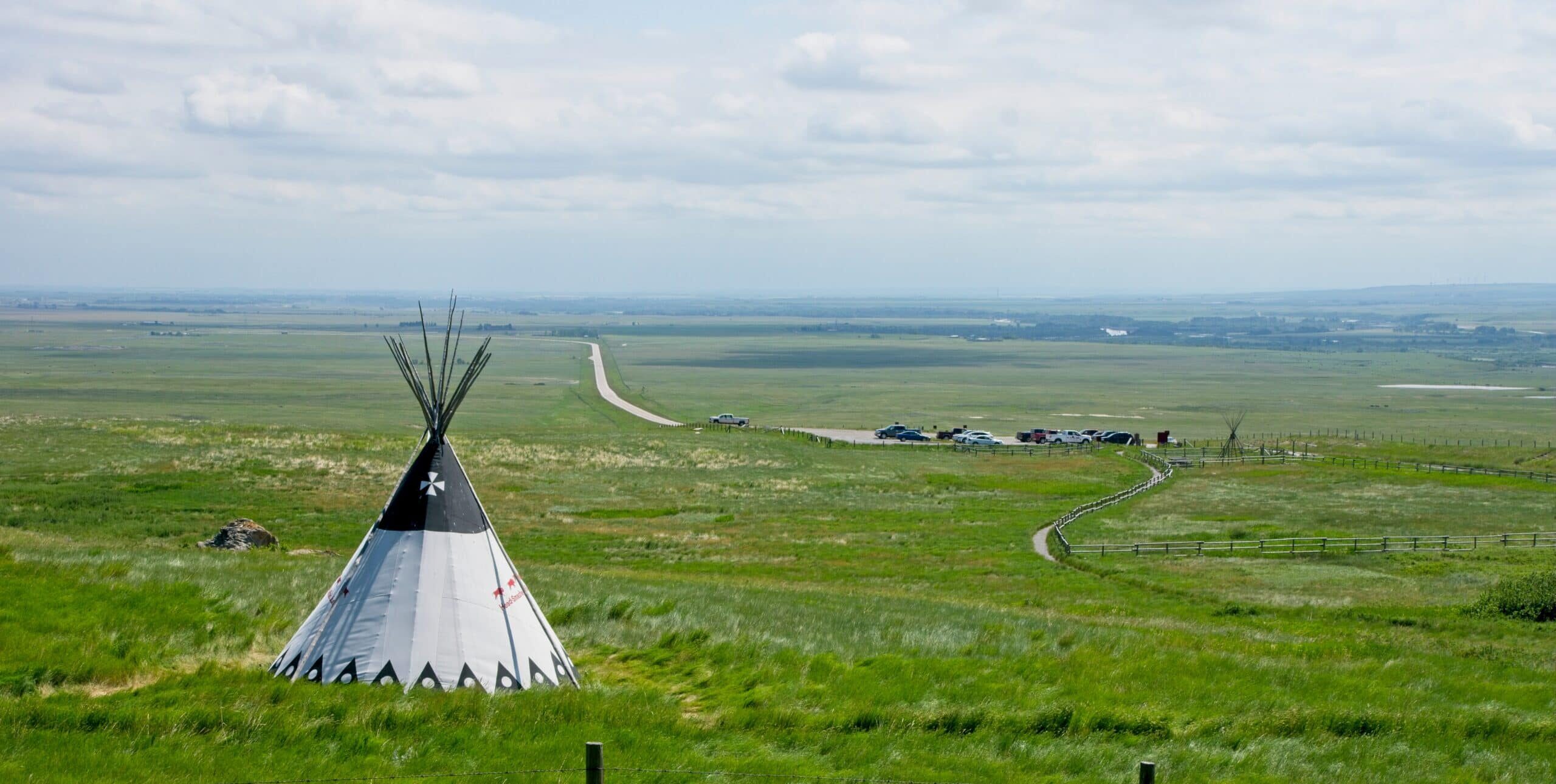 Tipi in a vast field.